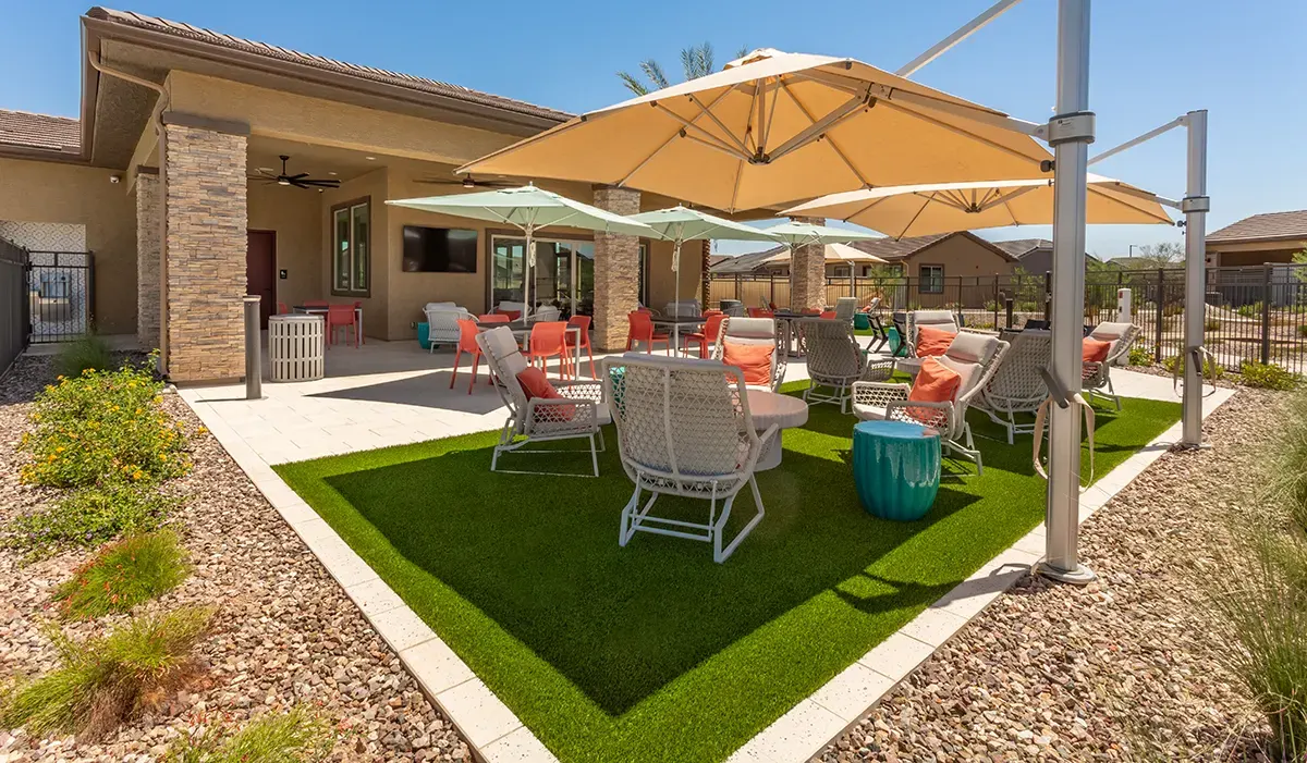 Shaded courtyard tables and lounge chairs at Village Sonoran Vista.