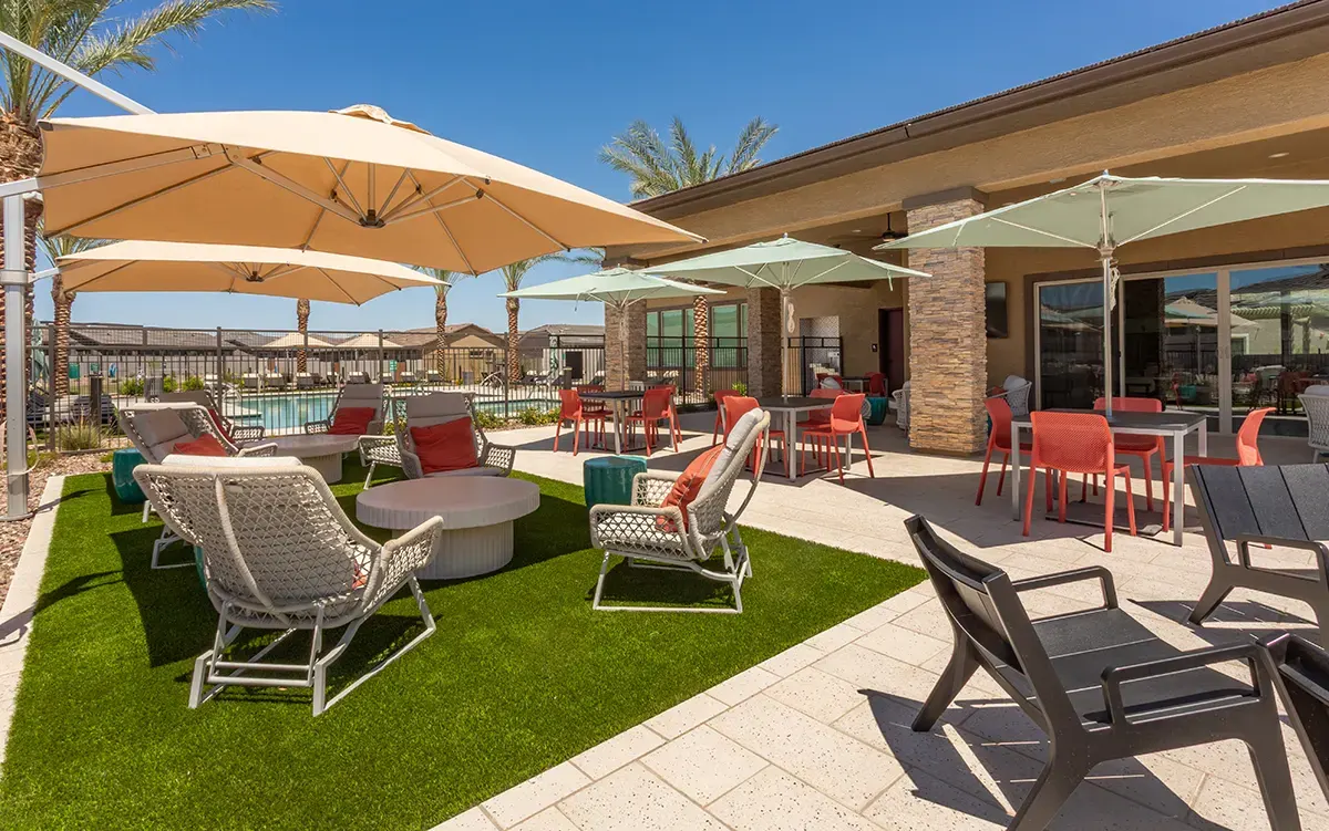 Courtyard seating under umbrellas at Village Sonoran Vista.