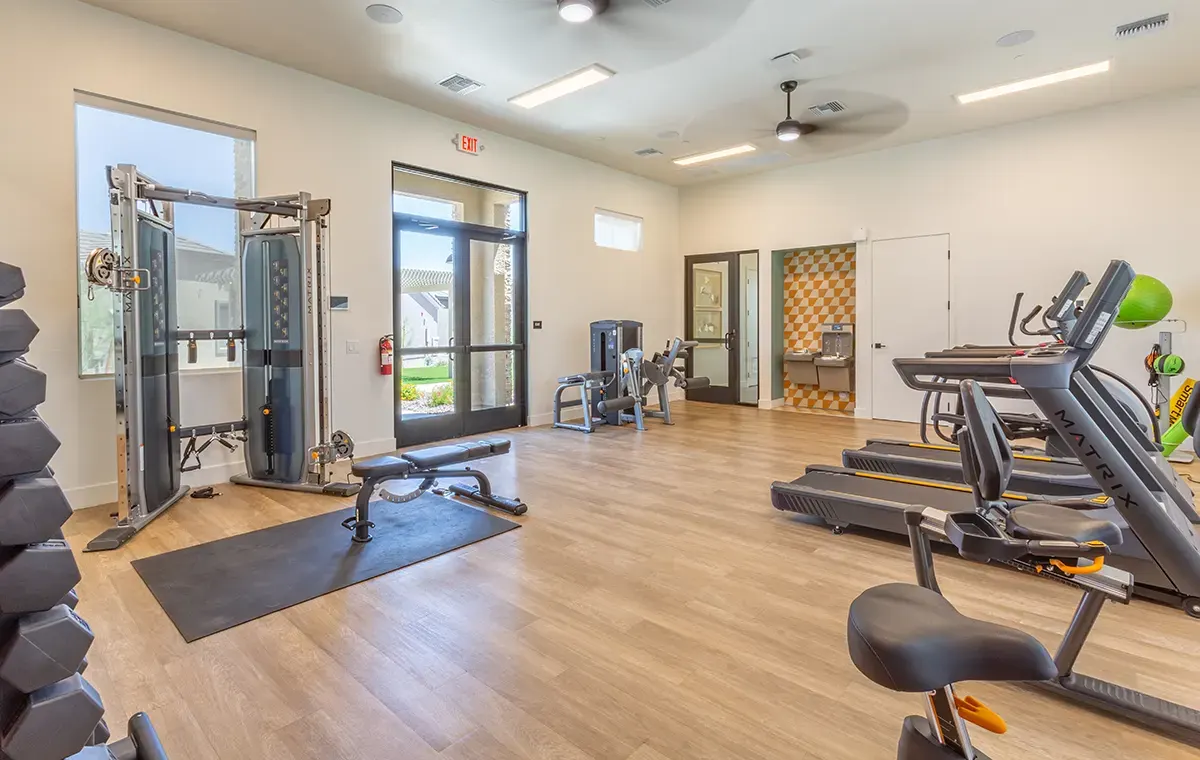 Fitness equipment beside exterior doors at Village Sonoran Vista.
