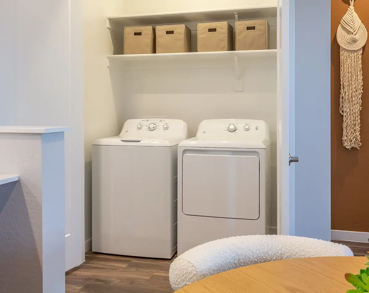 Washer and dryer in a laundry closet at Village Sonoran Vista.