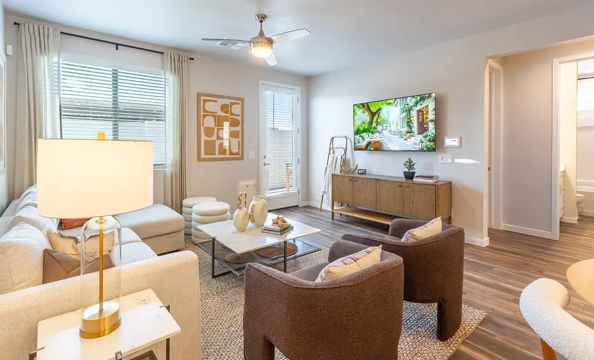Living room seating and television at Village Sonoran Vista.