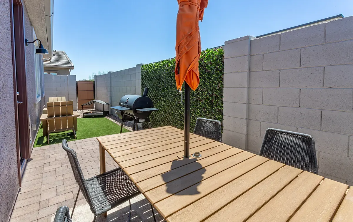 Enclosed patio with table and grill at Village Sonoran Vista.