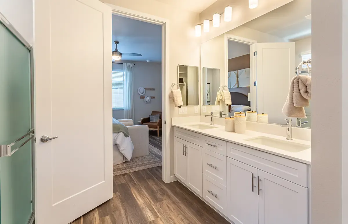 Bathroom vanity and bedroom doorway at Village Sonoran Vista.