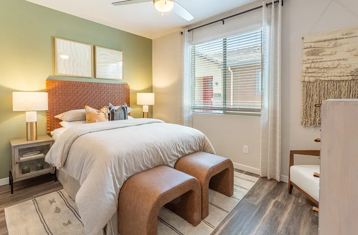Bedroom with upholstered headboard at Village Sonoran Vista.