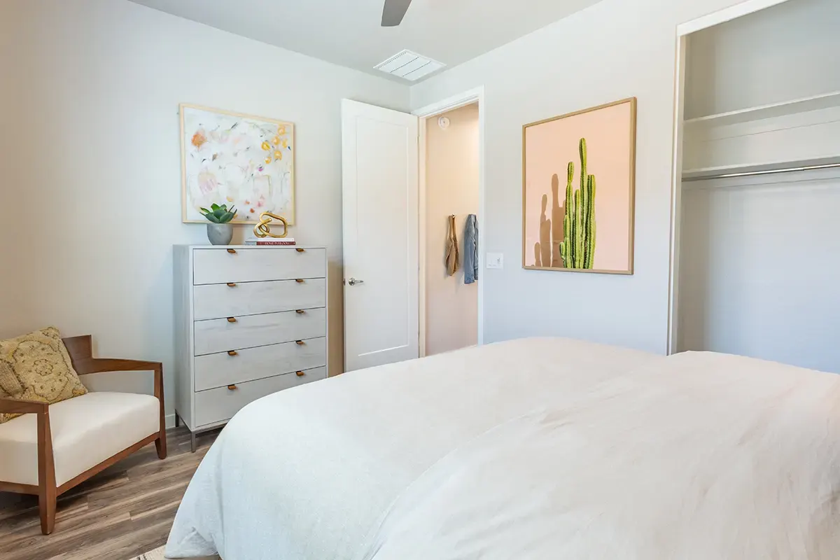 Bedroom with dresser and closet doorway at Village Sonoran Vista.