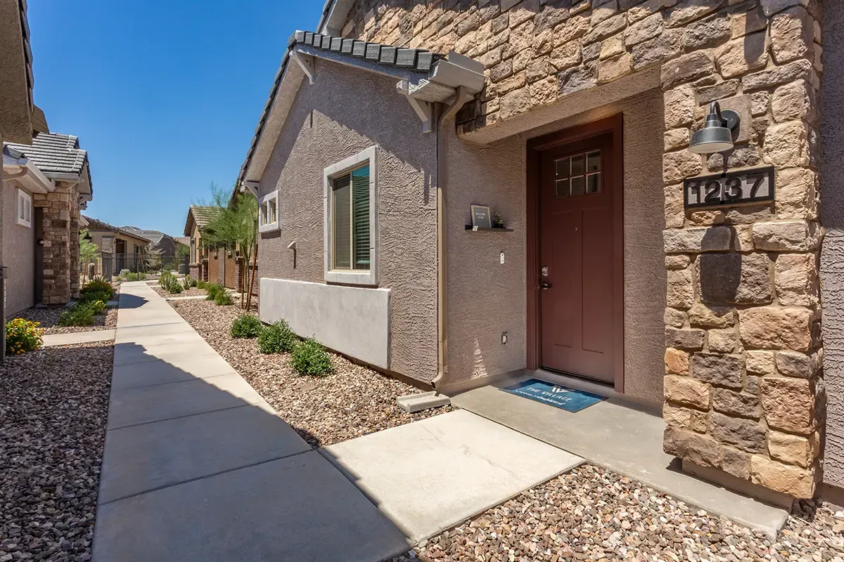 Single-story home entry and walkway at Village Sonoran Vista.