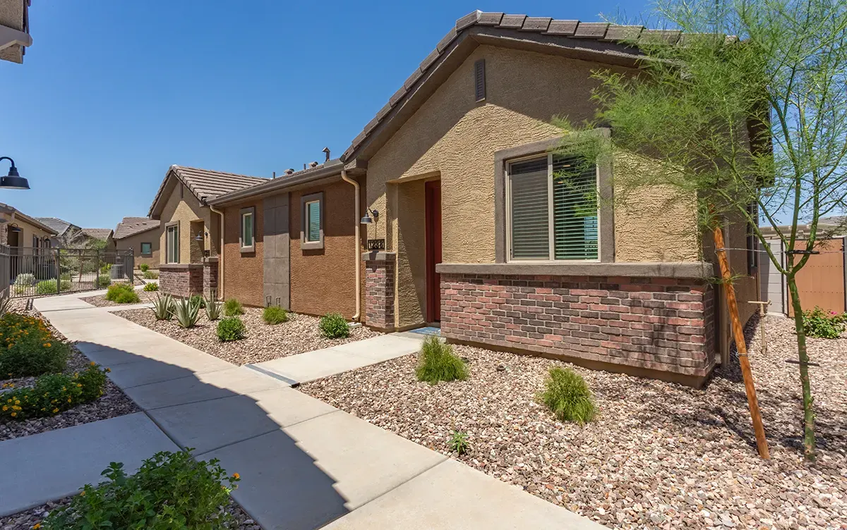 Rental homes beside a landscaped walkway at Village Sonoran Vista.