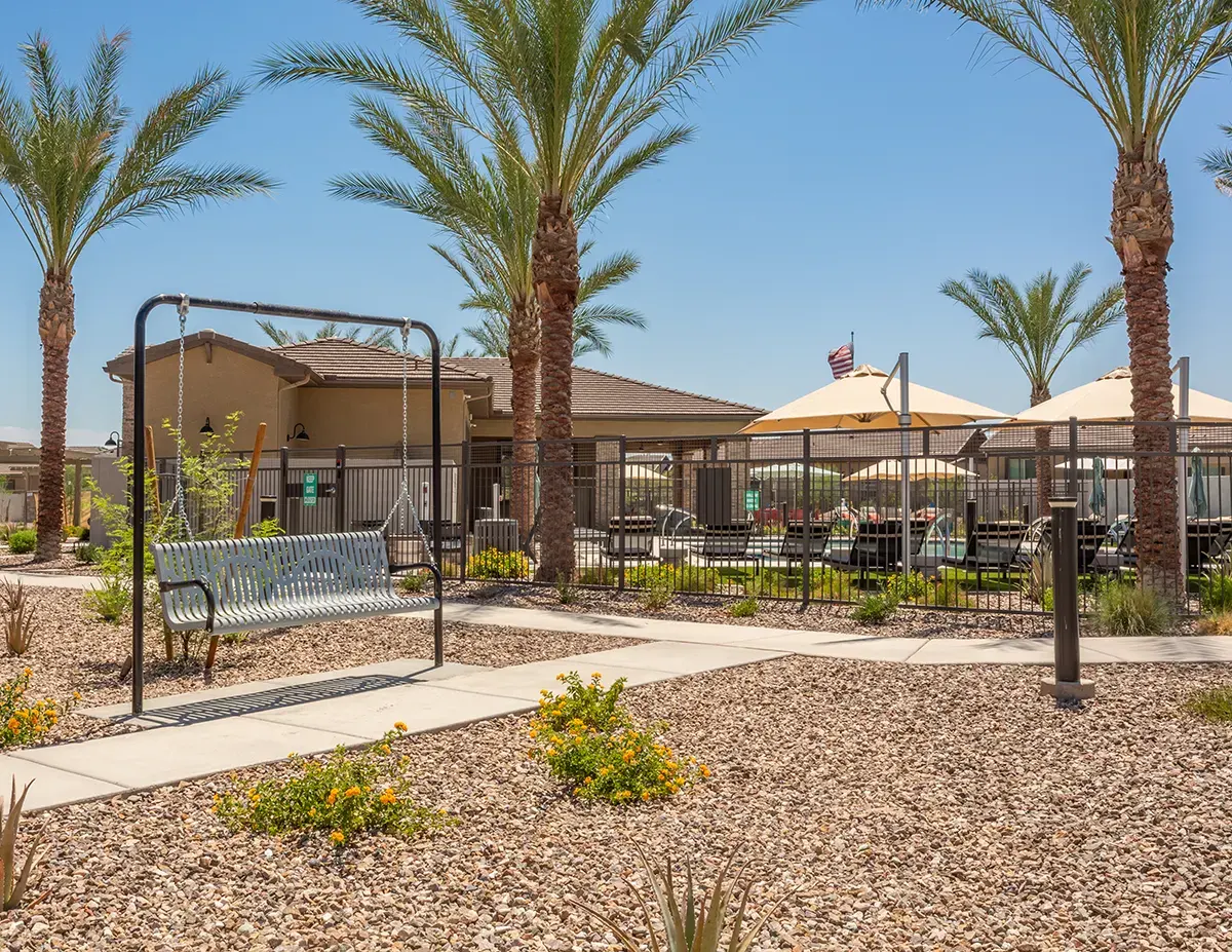 Clubhouse exterior and landscaped grounds at Village Sonoran Vista.